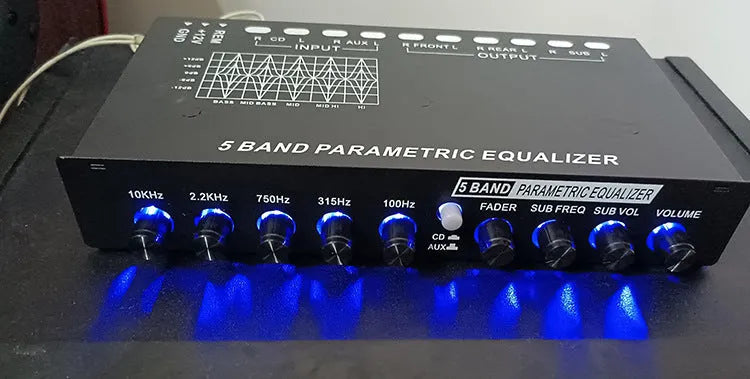 Black car audio equaliser amplifier unit with control knobs for 6-channel output and subwoofer tuning.