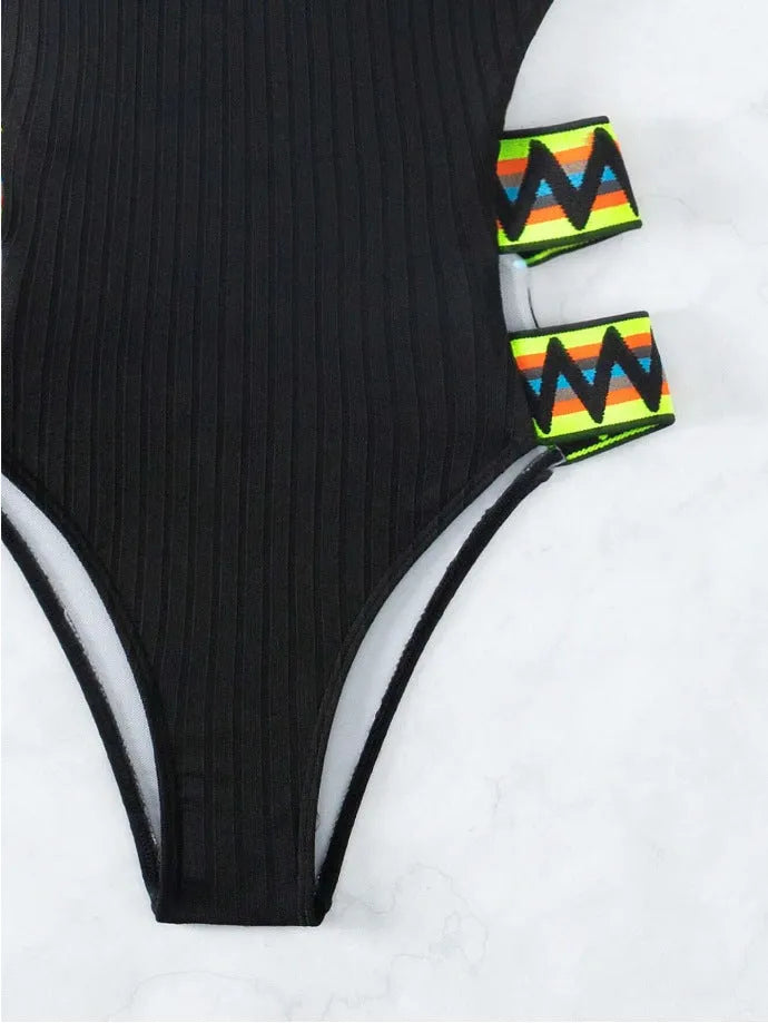 Women's solid colour one-piece swimsuit in black or orange, made from polyester fabric.