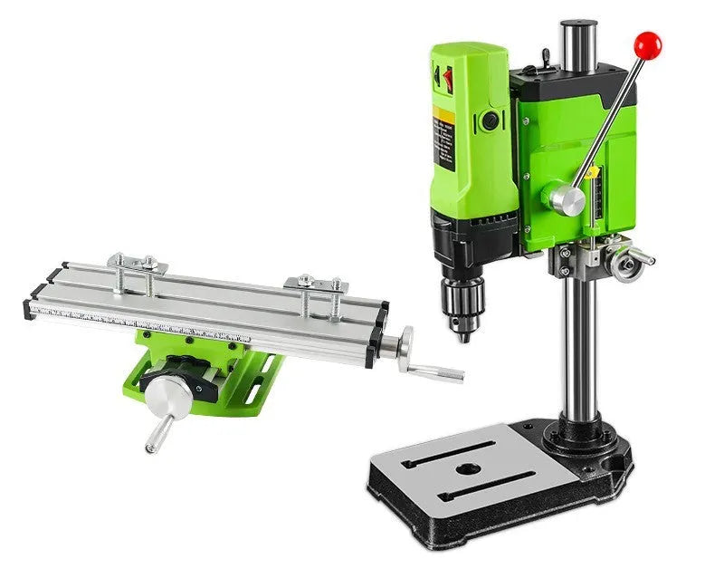 Mini bench drill and milling machine with heavy-duty bench pliers on a workbench.