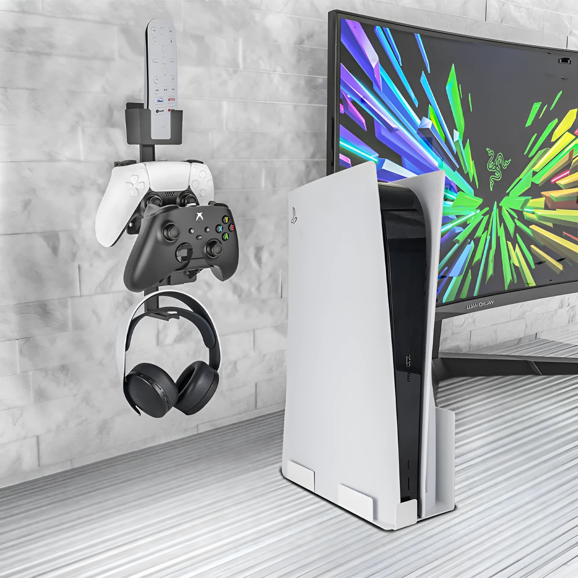 White wall-mounted plastic hook holding a game controller and remote control