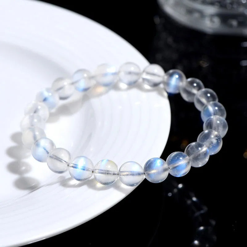 Natural cream coloured crystal bracelet with smooth ground beads, shown in a minimalist unisex style.