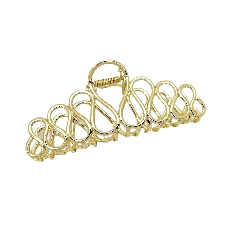 Minimalist large hair clip with tassel detailing in gold or silver metallic finish for updo hairstyles