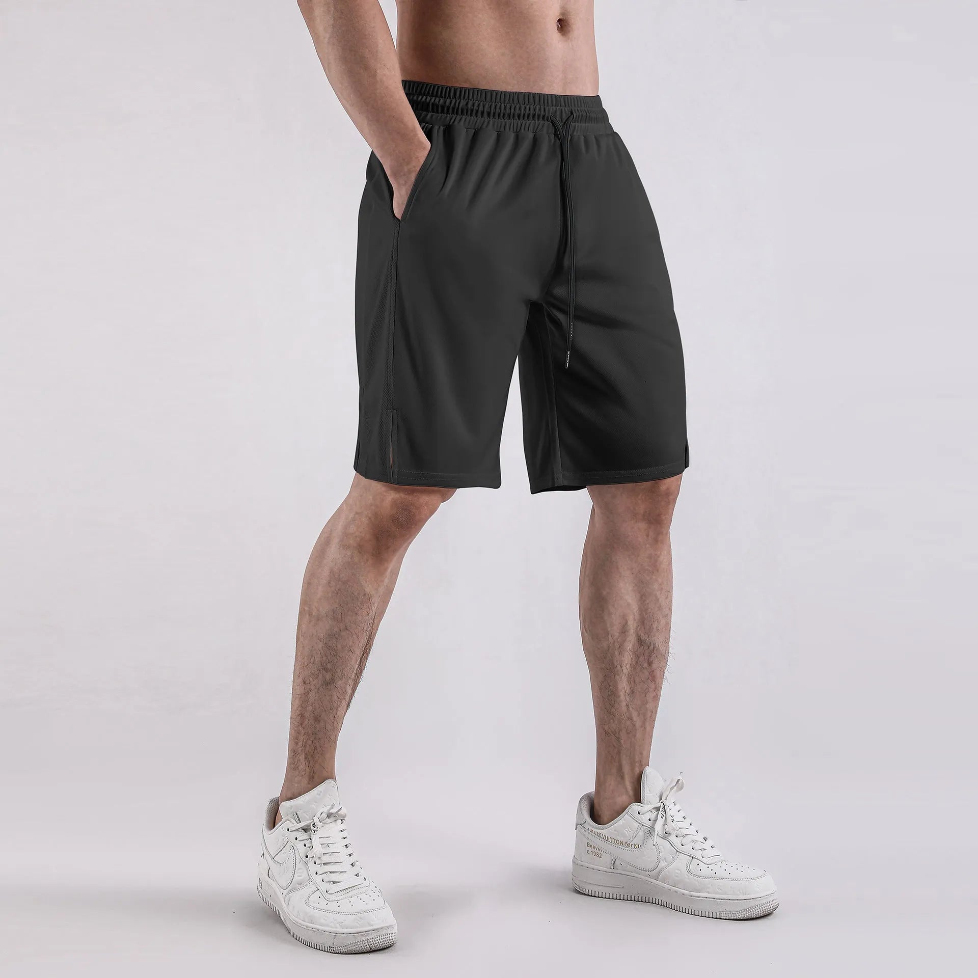 Man wearing loose black quick-drying capri pants for casual summer wear.