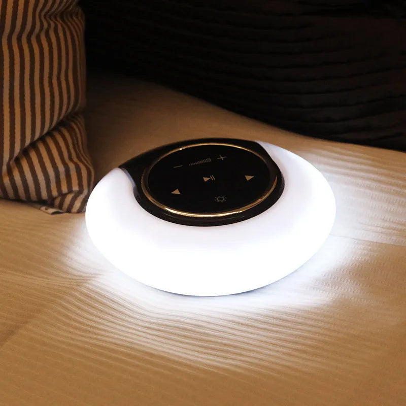 Square blue Bluetooth speaker lamp with touch controls, showing white LED light and folding design.