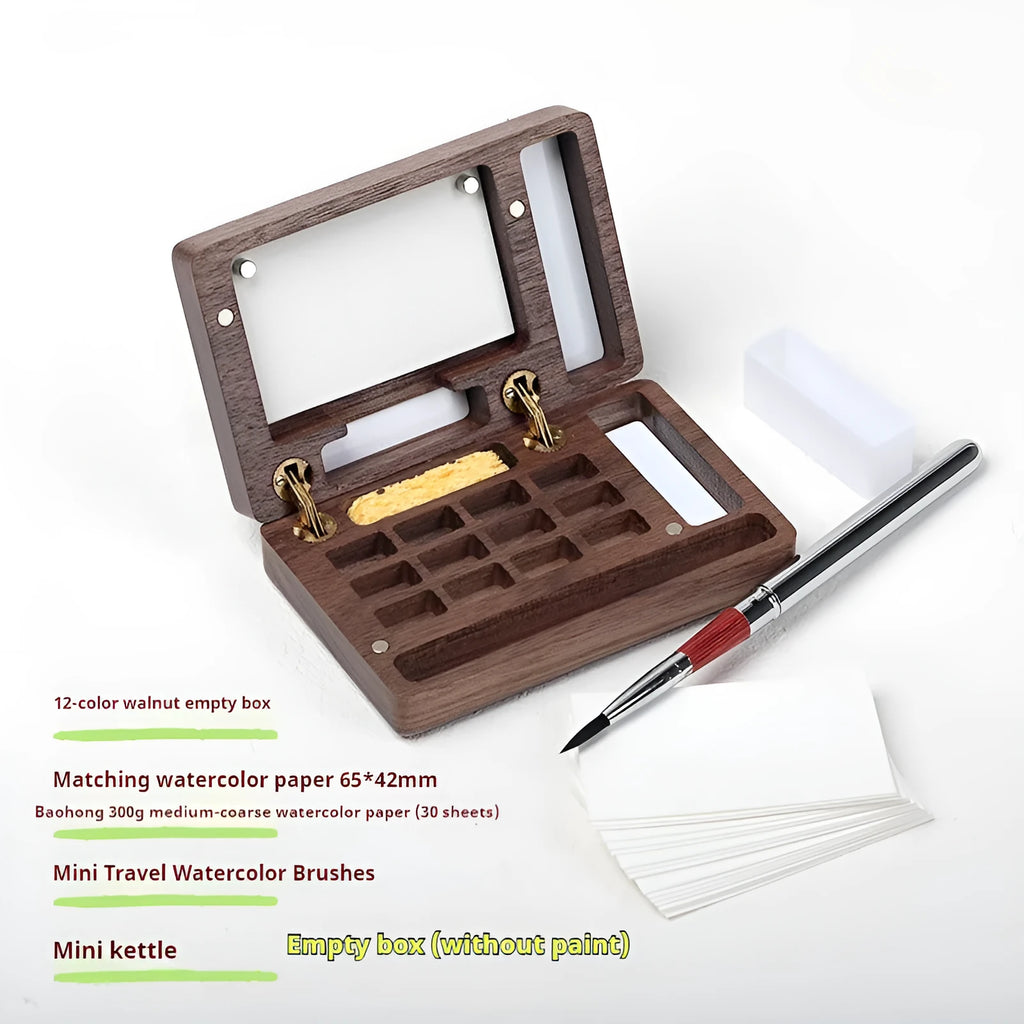Mini walnut wooden box open to show watercolour paint pans in a portable artist travel set.