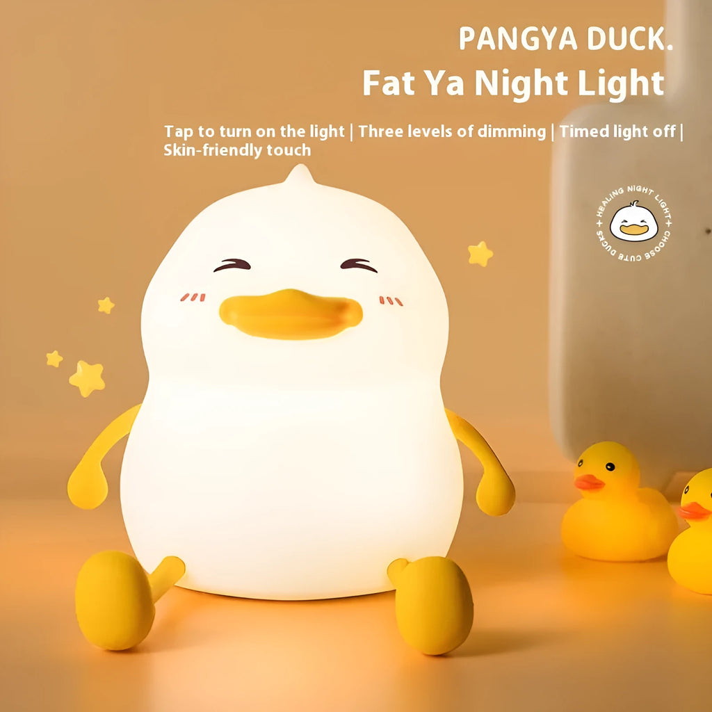 Chubby small night lamp with silicone pat design and integrated phone holder on desk