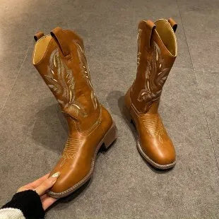 Brown women's mid-calf embroidered Martin boots with a leather lining and low rubber heel.