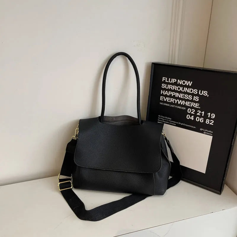 A brown PU tote bag with double shoulder straps and visible sewing thread detail.