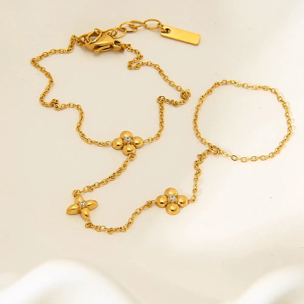 Gold colour women's bracelet with geometric eight-pointed stars and floral design elements on stainless steel
