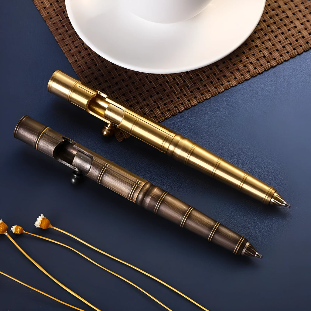 Brass tactical pen with bolt-action mechanism showing brushed finish and retro hole detailing