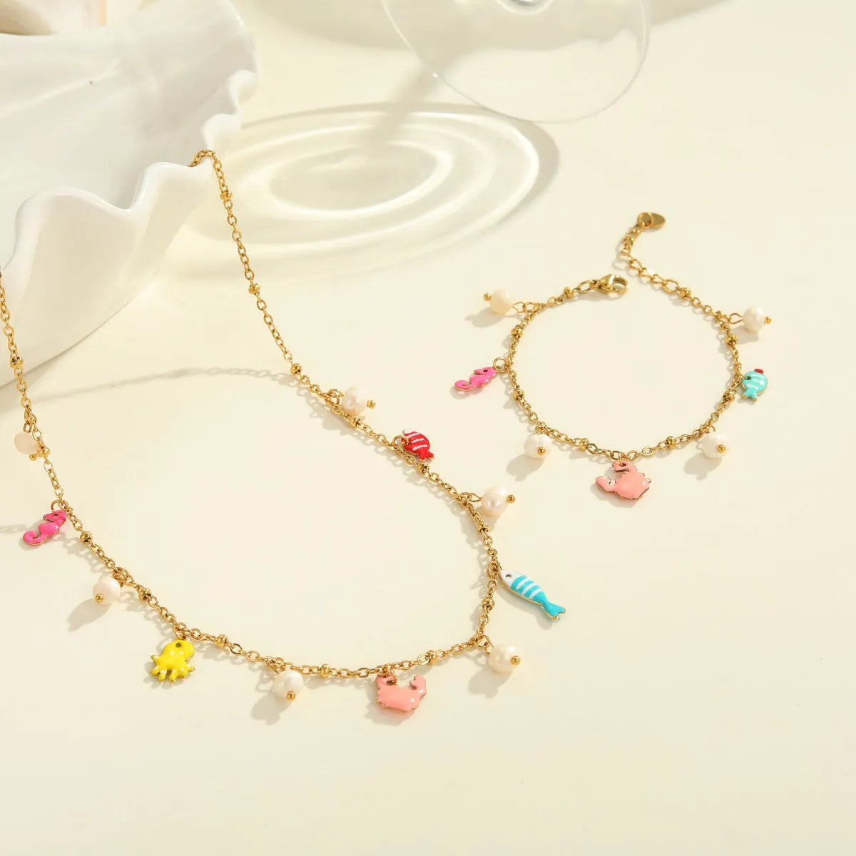 Stainless steel pendant necklace with geometric shape and 18K gold electroplating, paired with a titanium steel bracelet, for women