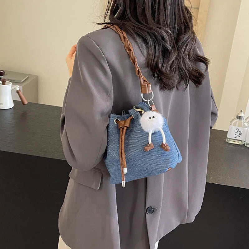 Blue synthetic leather cross body bucket bag with sandwich pocket construction