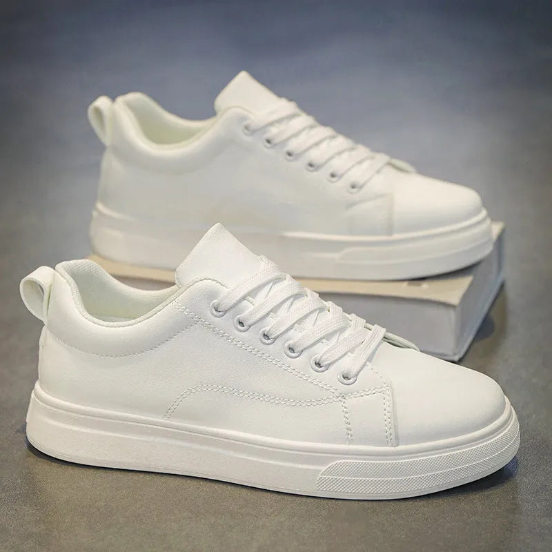 Men's low-top Korean-style casual sneakers in black on white colour with round toe and flat rubber sole.