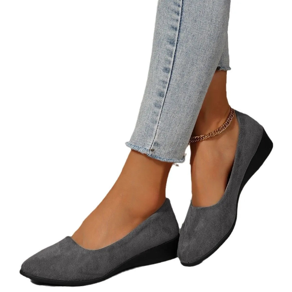 Women's black suede wedge pumps with pointed toe and low rubber sole on a light background