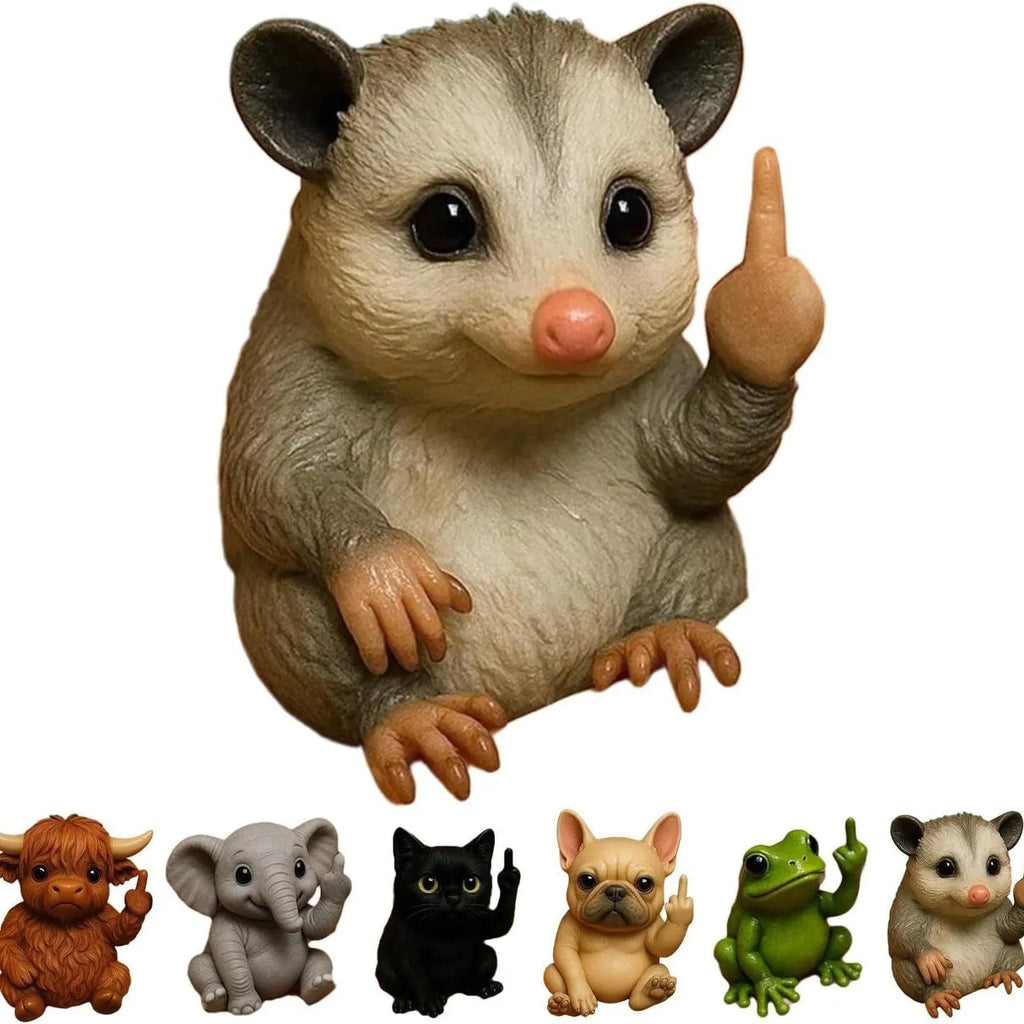 Mini animal-themed vertical middle finger doll ornament in resin and plastic on a desk.