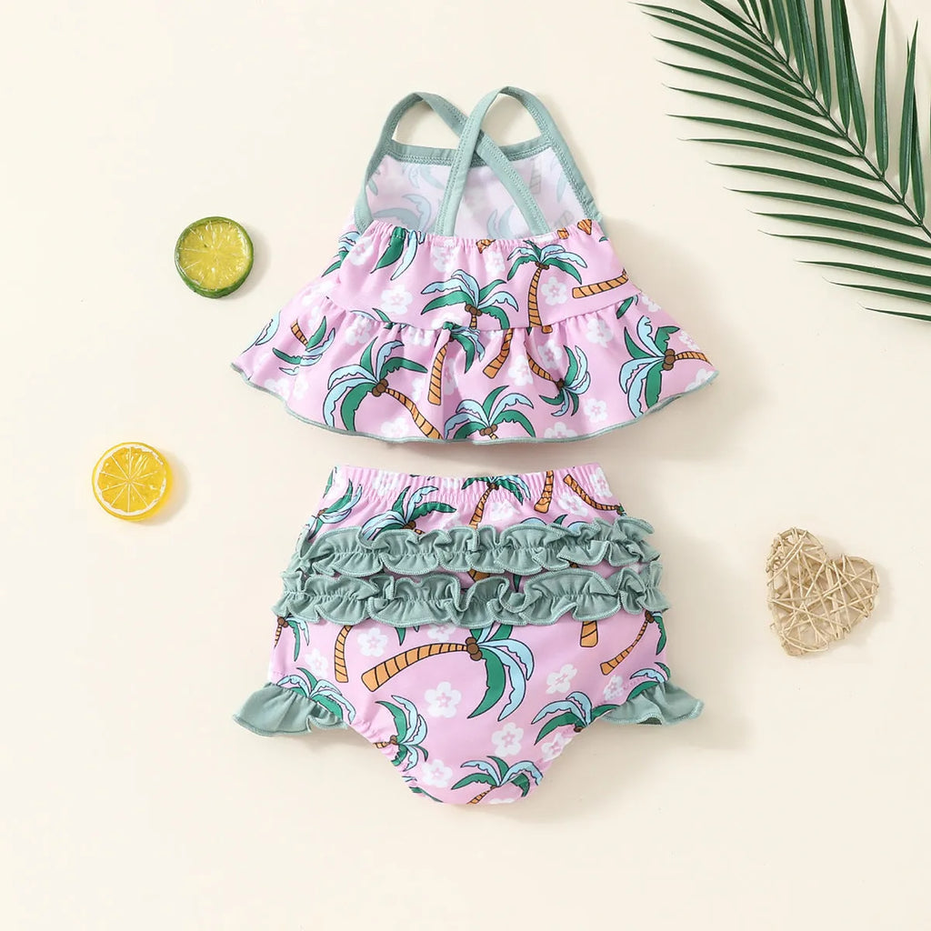 Girls' white two-piece swimsuit set with a shirt and matching shorts on a hanger