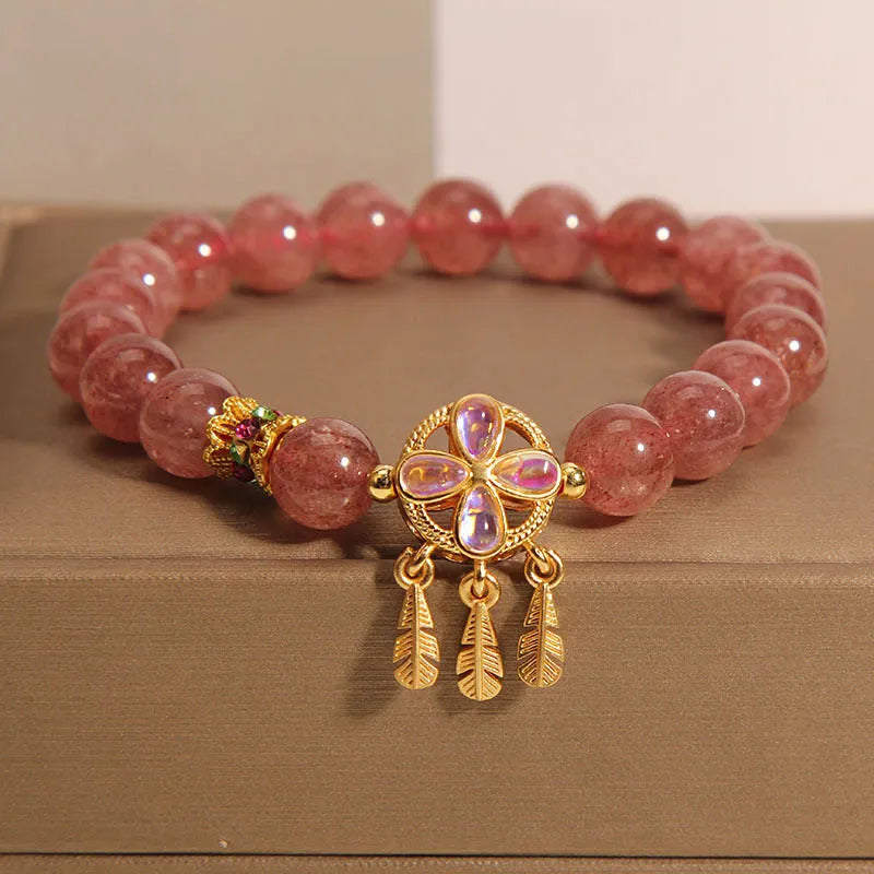 Women's strawberry quartz bracelet with four-leaf dream catcher pendant on crystal beads