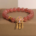 Women's strawberry quartz bracelet with four-leaf dream catcher pendant on crystal beads