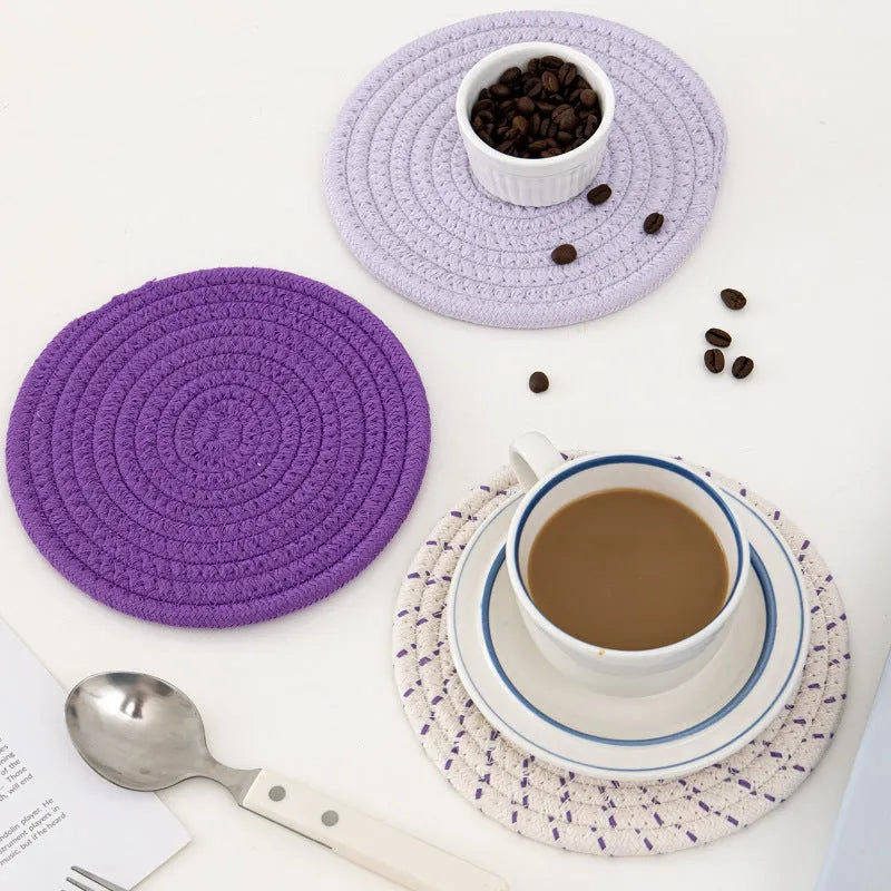 Set of three round cotton cord coasters in a choice of colours on a wooden table