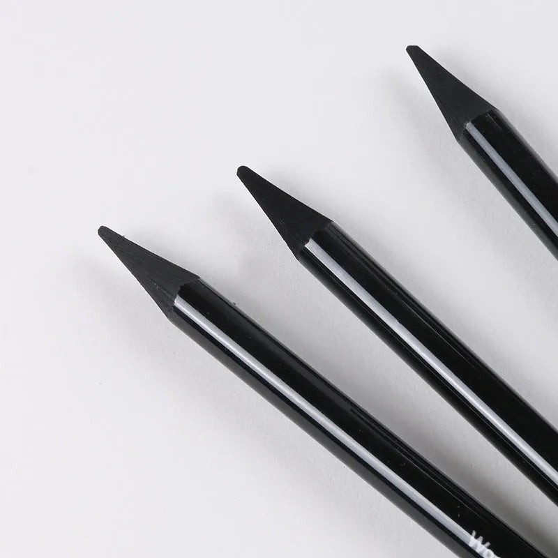 Set of nine wooden artist pencils including graphite and carbonized types on suction card packaging