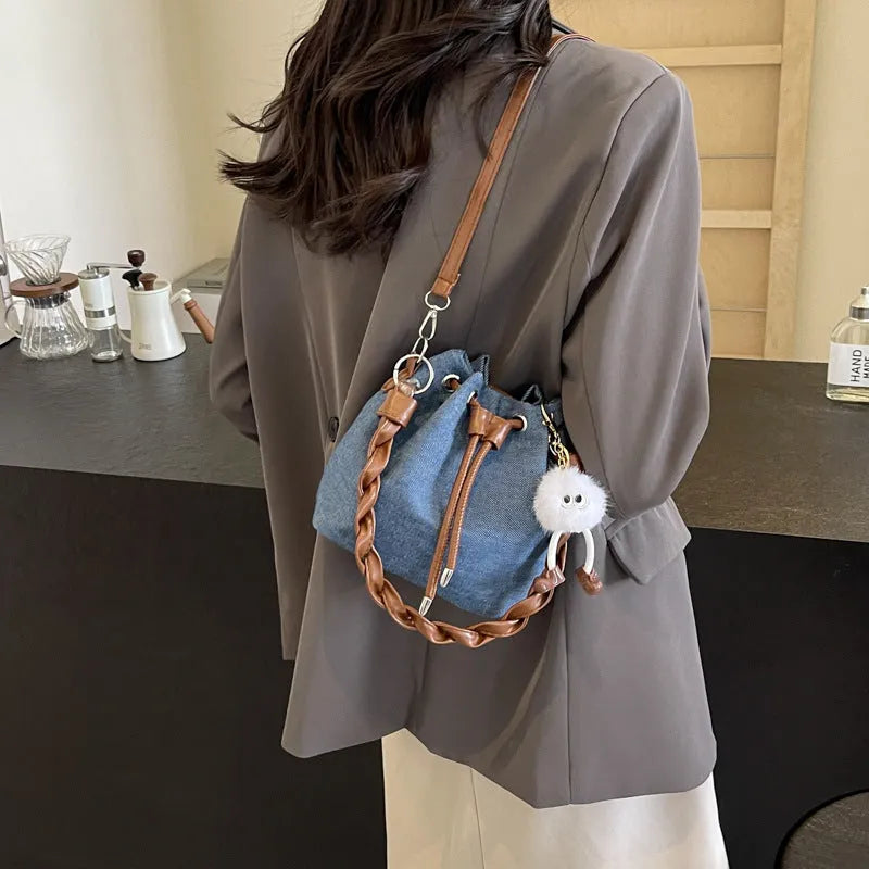 Blue synthetic leather cross body bucket bag with sandwich pocket construction