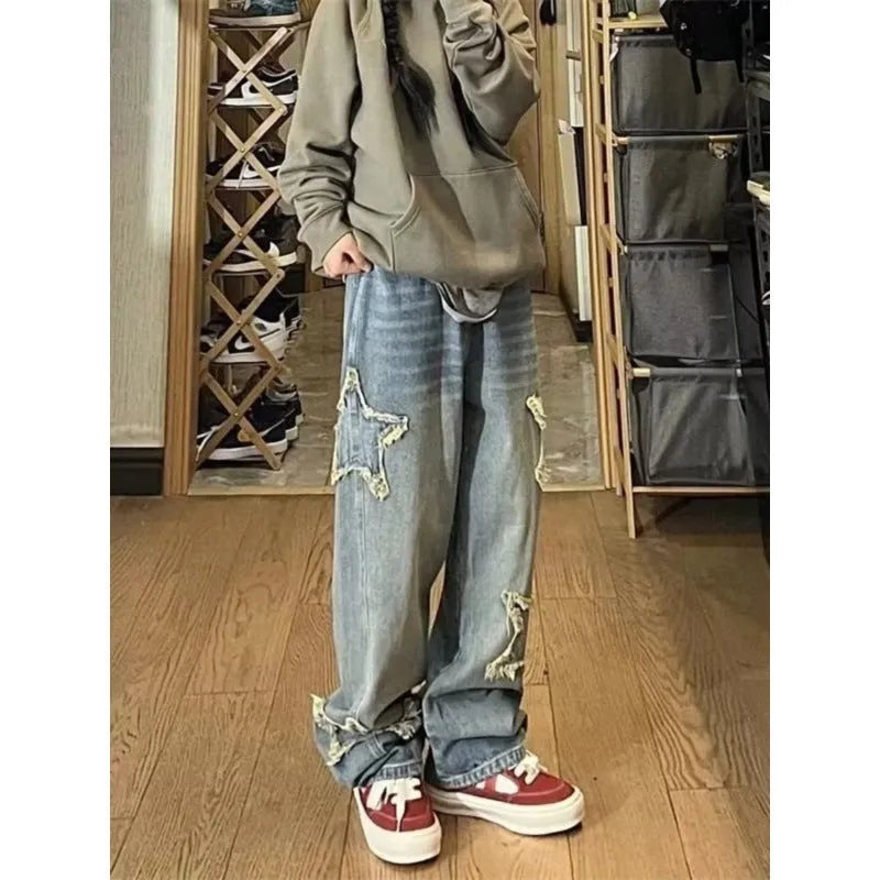 Blue high-waisted wide-leg denim trousers laid flat, showing straight cut and front detail.