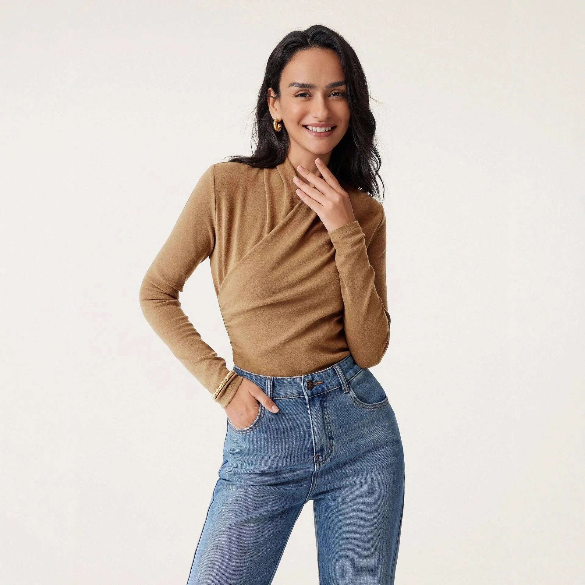 Camel-coloured women's slim fit pullover sweater with long sleeves on a hanger.
