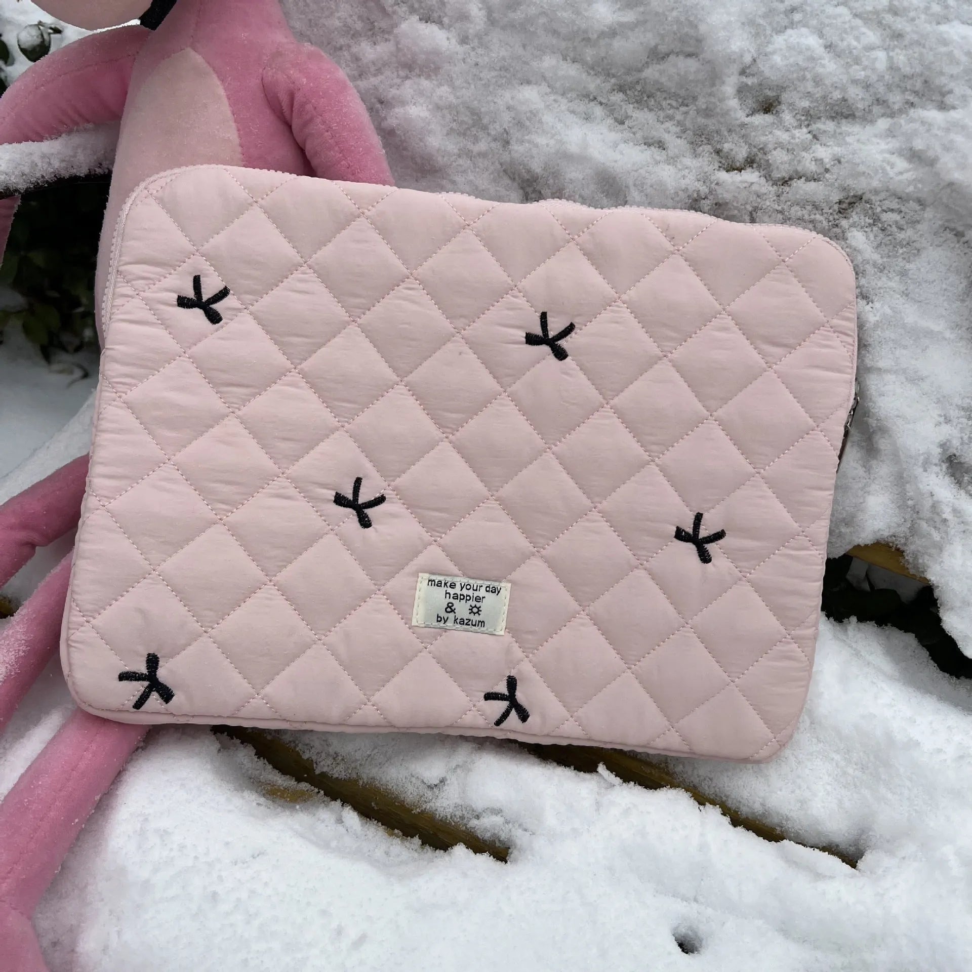 White nylon laptop bag with embroidered rhombus pattern and fabric bow, shown alongside black, light blue, and light pink colour options.