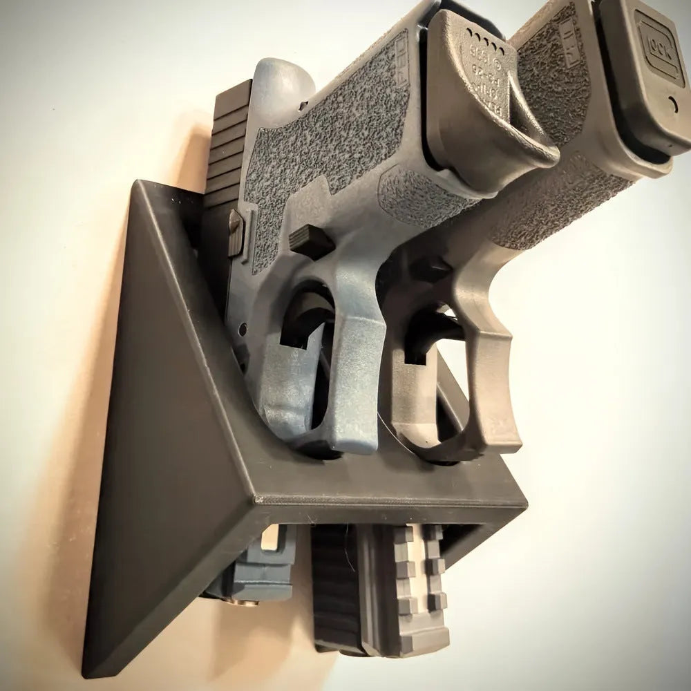 Black plastic pistol display stand with a punk-style design for gun replicas.