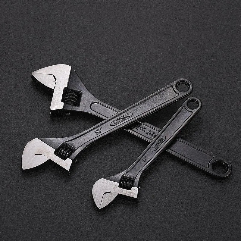 High carbon steel adjustable open-end wrench with blackened finish on a grey background.