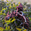 3D printed red and gold flying dragon wings decoration toy on a white background.