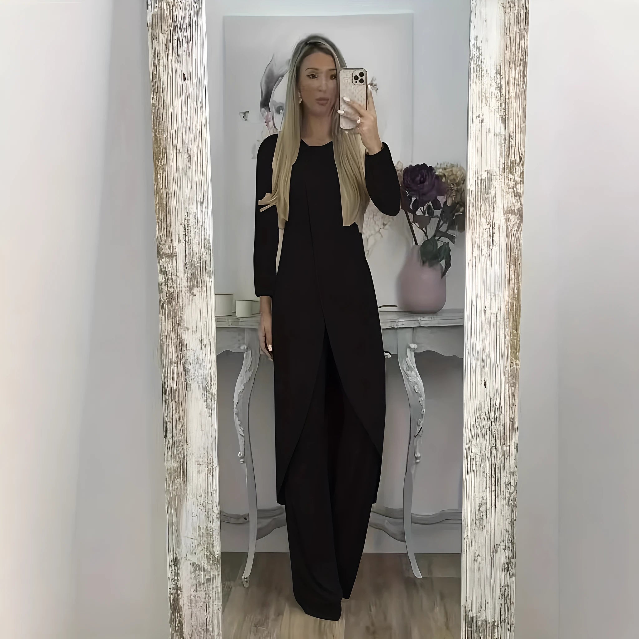 Black loose fit casual two-piece lounge set with long sleeve top and trousers on a hanger.