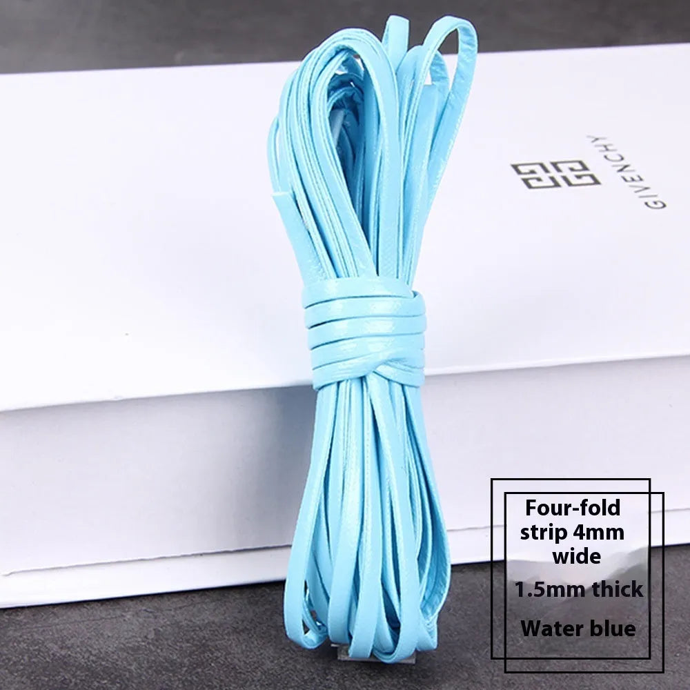 Coils of woven PU leather craft cord in various colours including black, brown, blue, red, and gold.