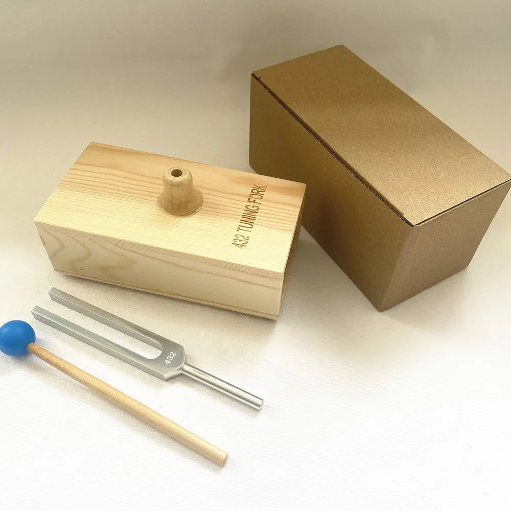 Aluminium alloy 432Hz tuning fork with connected speaker on kraft paper box