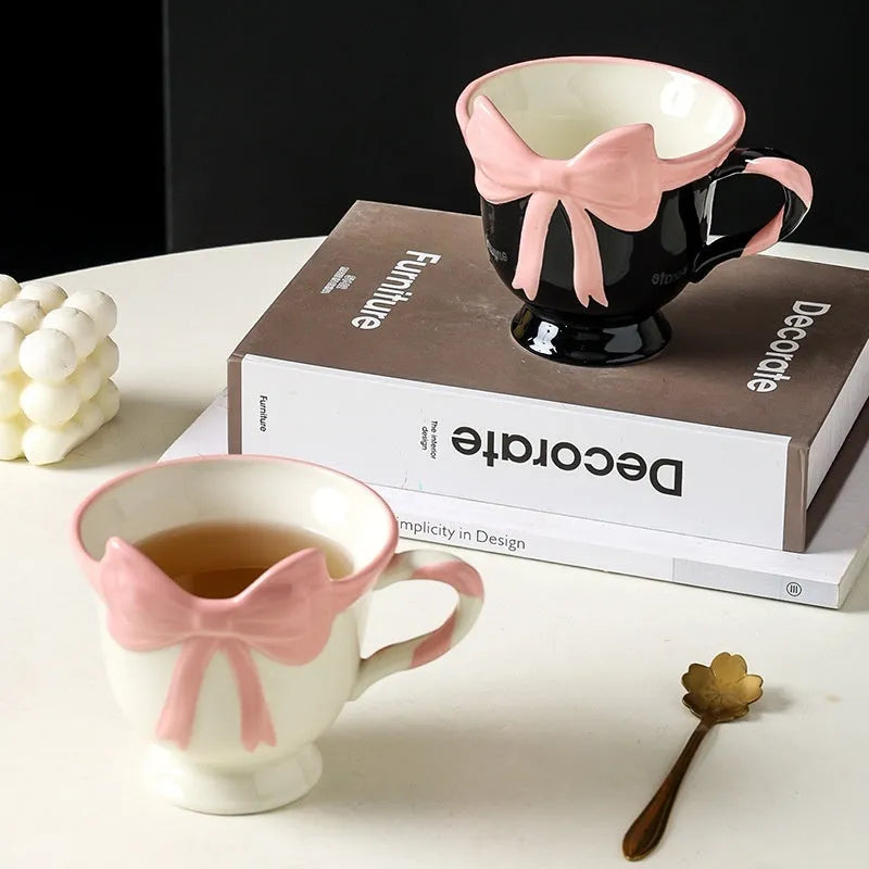 Ceramic mug with a decorative heart bow design in black pink or white powder colour.