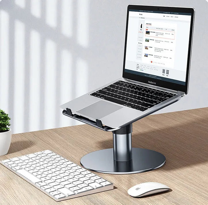 Silver aluminium car laptop stand with adjustable height and rotating base on a car seat.