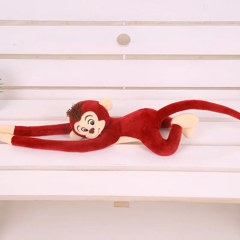 Long arm hanging monkey plush toy in pink, 70cm height, curled around a curtain rod for home decoration