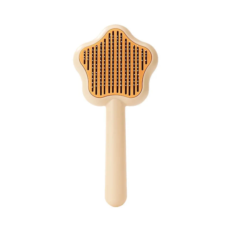 Self-cleaning stainless steel cat comb with green handle, showing 4-row needle design
