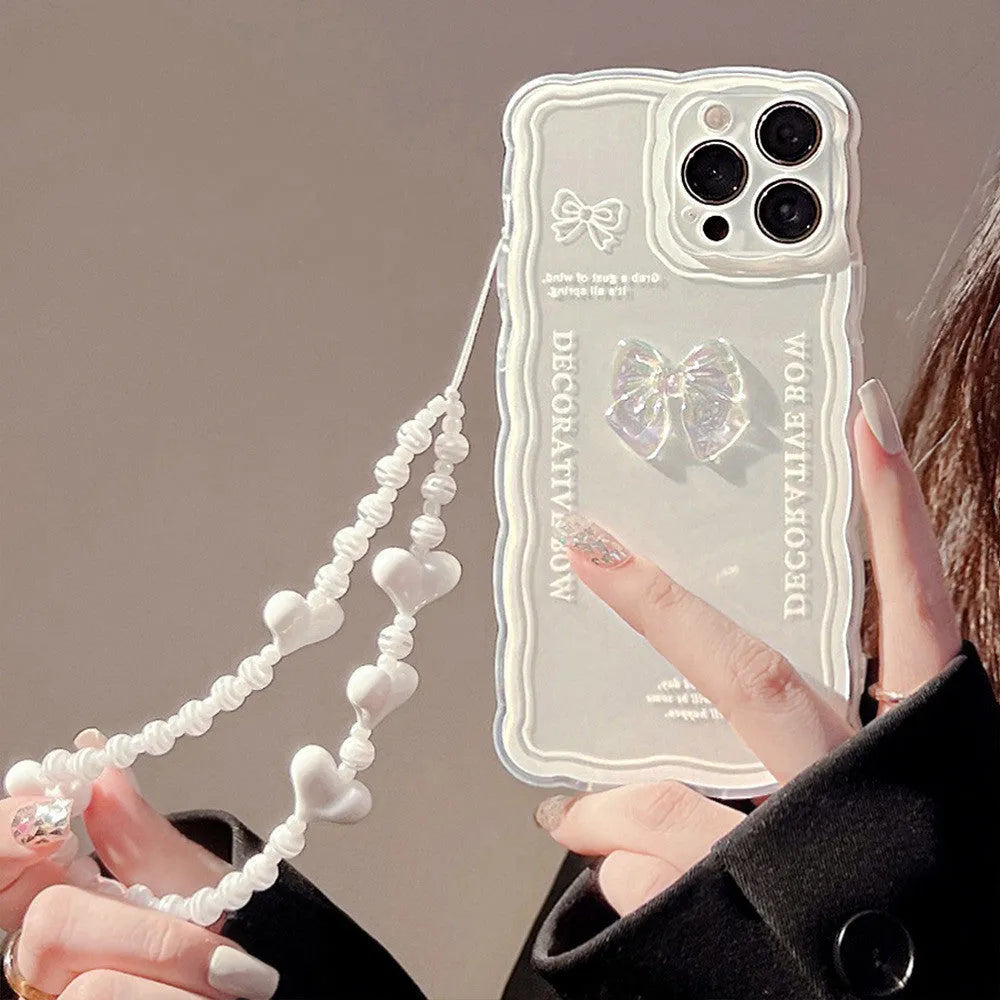 Transparent iPhone case with raised ice-through bow design and white love lanyard attachment