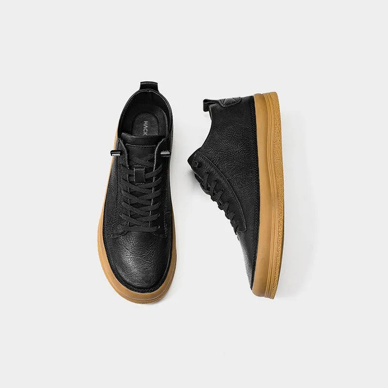 Men's black casual leather shoes with round toe, flat heel, and lace-up front on a white background.