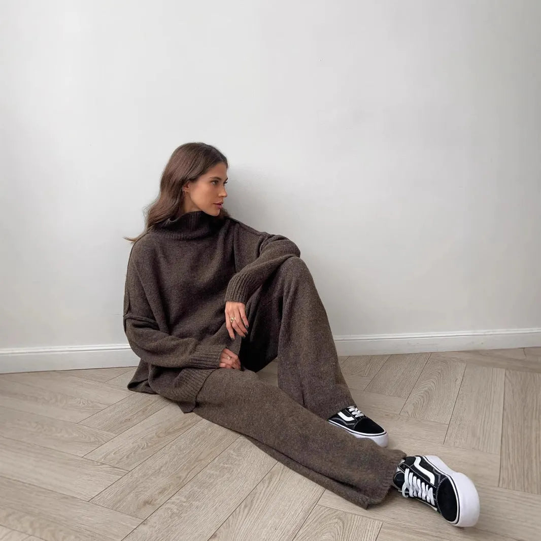 Women's dark grey acrylic knit sweater and trouser suit with a side-slit design on the top.