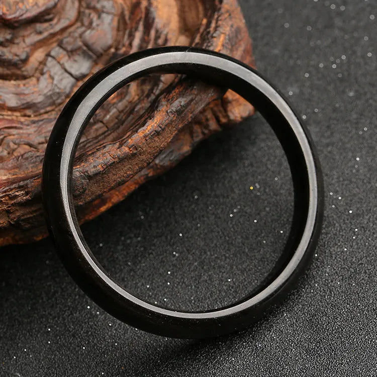 Geometric ethnic obsidian bracelet with a cat's eye gemstone in natural silver stone colour.