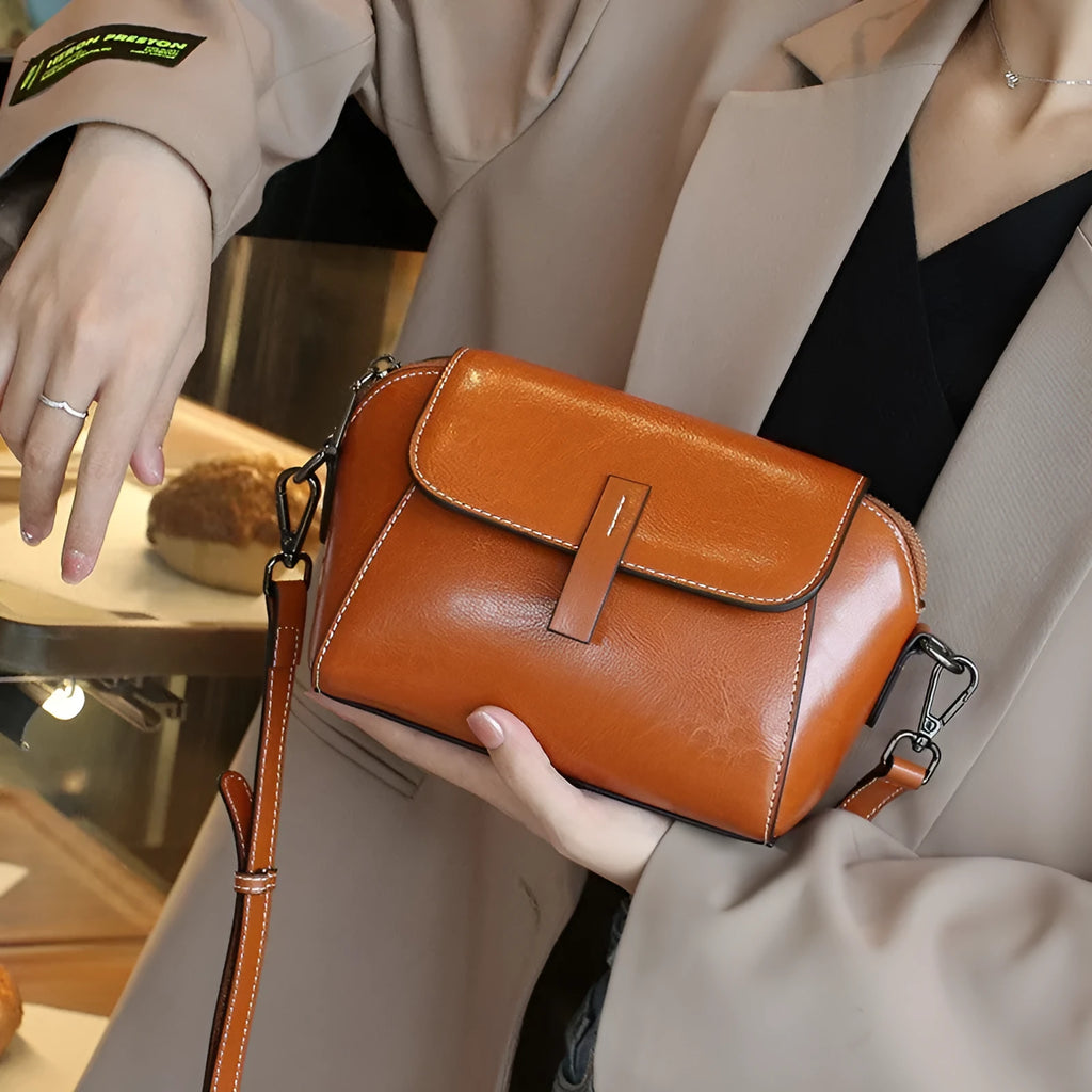 Women's brown oil wax cowhide leather messenger bag with cross-body strap and internal compartments