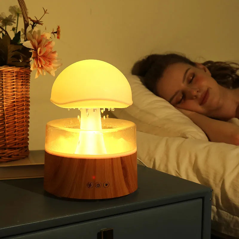 White rain cloud shaped humidifier with falling water droplets and multi-colour lighting