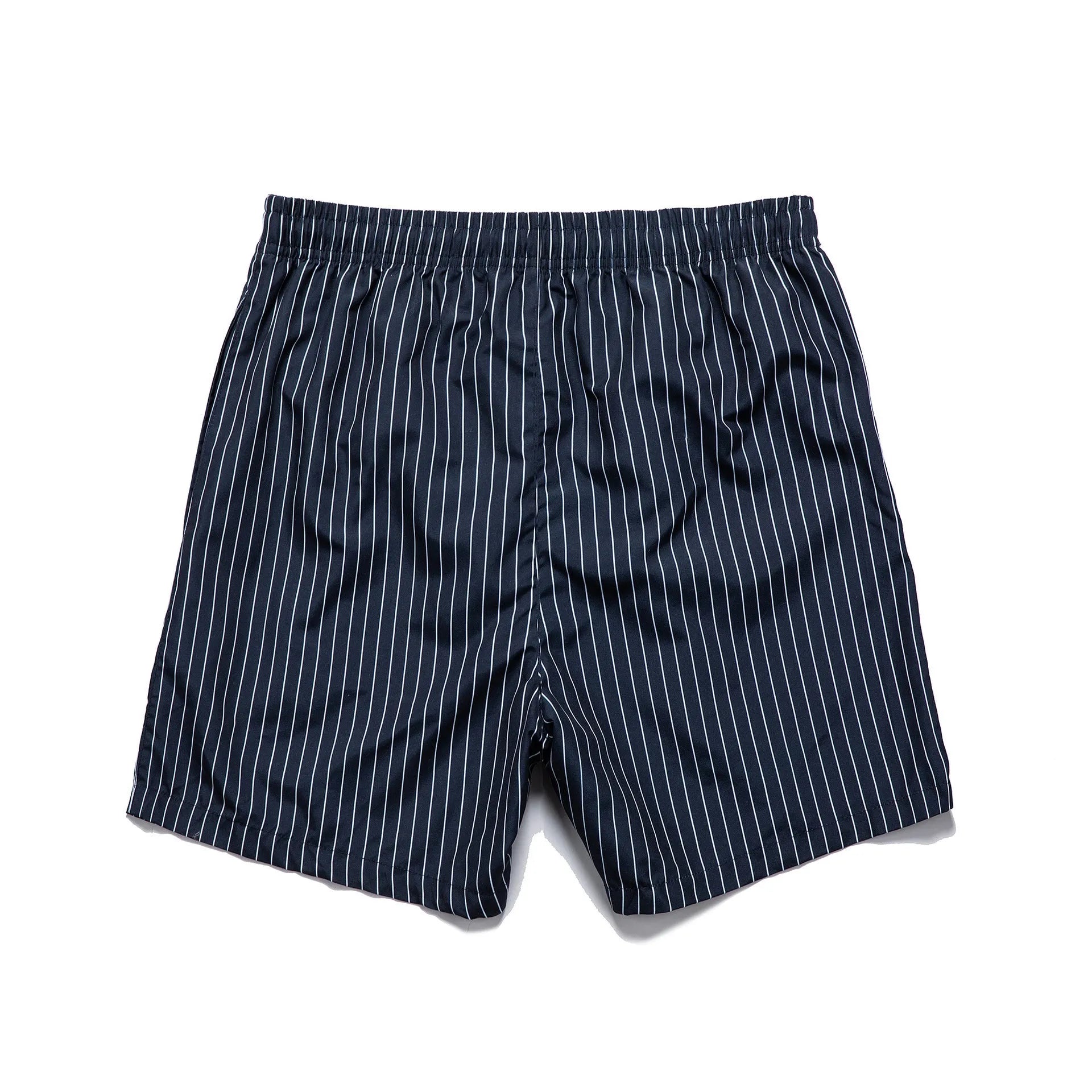 Man wearing grey striped polyester beach shorts with a straight leg opening