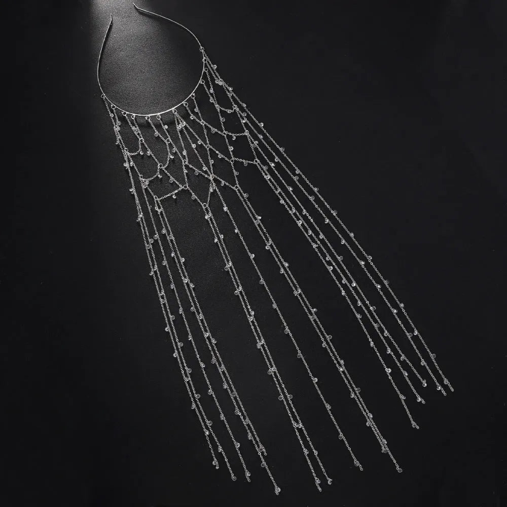 Gold coloured rhinestone hair band with a draped mesh tassel decoration.