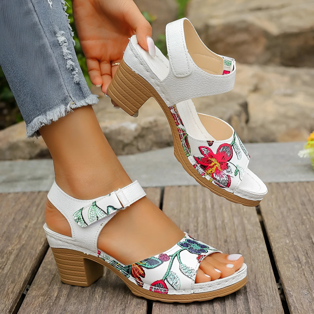 White women's high heel sandals with a Velcro strap closure on a rubber sole.