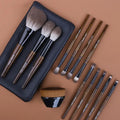 12-piece makeup brush set with wooden handles and a grey PU storage bag