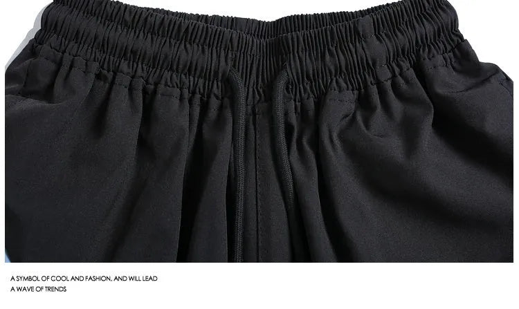 Men's loose fit quick-drying sports shorts with elastic waist in black and grey colours