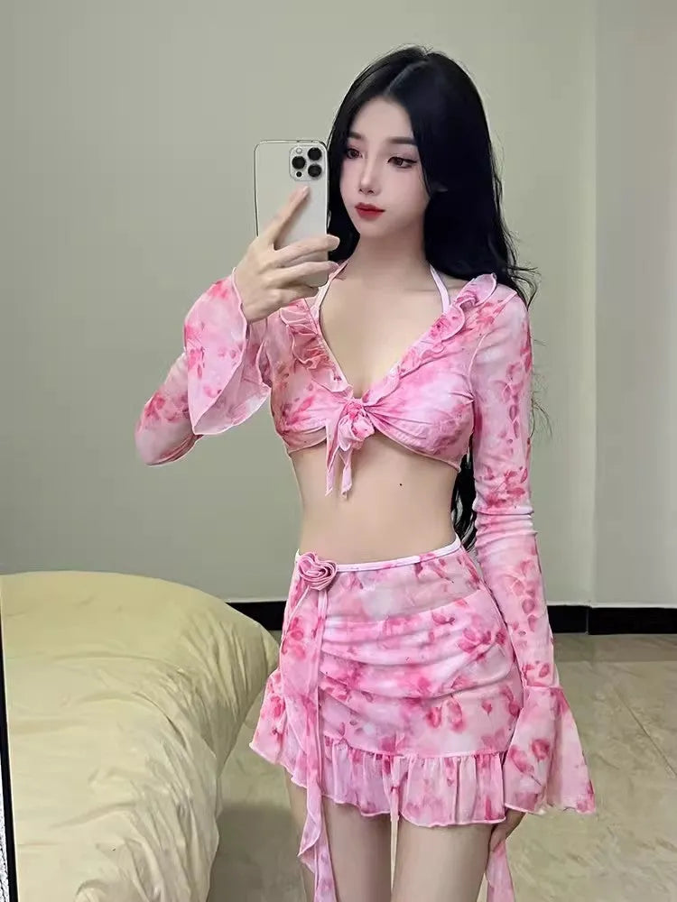 Women's cherry blossom pink floral bikini swimsuit laid flat.